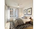 Bright bedroom with a king-size bed, window, and patterned rug at 106 Broadway St # 207, Durham, NC 27701