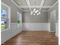 Formal dining room with hardwood floors and a tray ceiling at 15 Nebbiolo Dr, Youngsville, NC 27596