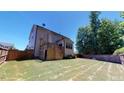Two-story house back with deck, pergola, and fenced backyard at 104 Abbeville Ln, Holly Springs, NC 27540