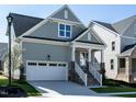 Gray house with white garage door and stone accents at 1717 Grassy Falls Ln, Wendell, NC 27591