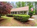 Ranch style home with a covered porch and American flag at 2723 New Sharon Church Rd, Hillsborough, NC 27278