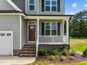 Front entry with red door and brick steps at 30 Diamond Creek Dr, Zebulon, NC 27597