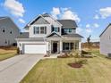 Two-story house with gray and beige siding, a two-car garage, and a well-manicured lawn at 545 Husketh Rd, Youngsville, NC 27596