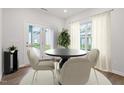 Bright dining room with table and four chairs, and access to backyard at 620 Georgias Landing Pkwy # 81, Raleigh, NC 27603