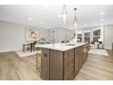 Modern kitchen island with white quartz countertop and gold barstools at 960 Myers Point Dr # 40, Morrisville, NC 27560