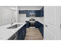 Modern kitchen with dark blue cabinets and quartz countertops at 816 Pryor St # 54, Mebane, NC 27302