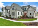 Side view of a white brick house with landscaping and walkway at 8916 Grand Highland Way, Wake Forest, NC 27587
