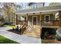 Inviting front porch with wooden steps leading to the front door at 109 Wy Dr, Louisburg, NC 27549