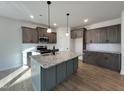 Modern kitchen with gray cabinets, granite countertops, and island at 97 Calluna Dr, Clayton, NC 27520