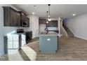 Modern kitchen with gray cabinets, granite countertops, and an island at 97 Calluna Dr, Clayton, NC 27520