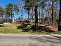 Ranch home nestled among tall trees and green grass at 3007 Old Raleigh Rd, Apex, NC 27502
