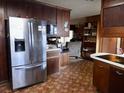 Kitchen features stainless steel refrigerator and wood cabinets at 3007 Old Raleigh Rd, Apex, NC 27502