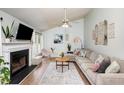 Spacious living room with vaulted ceiling, fireplace, and large sectional sofa at 2205 Moon Water Way, Garner, NC 27529