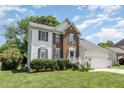Two story brick and white sided home with attached garage at 2205 Moon Water Way, Garner, NC 27529