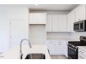 Modern white kitchen with stainless steel appliances and an island at 218 Sweetbay Tree Dr, Wendell, NC 27591