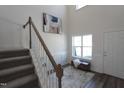 Bright and airy entryway with staircase, wood floors, and a coat bench at 1110 Talisker Way # 76, Burlington, NC 27215