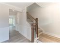 Modern staircase with dark wood railing and light walls at 2023 Seneca Dr # 32, Raleigh, NC 27604