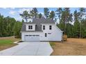 Rear view of house showing deck, garage and backyard at 190 Whistlers Cv, Louisburg, NC 27549