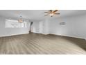 Bright living room featuring wood-look floors and a ceiling fan at 3915 Swinton St, Raleigh, NC 27616