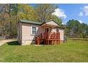 One-story home with green roof, wooden deck, and lawn at 221 Stroud St, Sanford, NC 27330