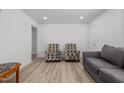 Bright living room with two armchairs and a gray couch at 221 Stroud St, Sanford, NC 27330