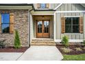 Inviting front entry with double doors and stonework at 112 Lambert Ln, Fuquay Varina, NC 27526