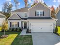 Two-story home with gray siding and landscaping at 580 Husketh Rd, Youngsville, NC 27596