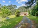 Brick ranch house nestled on a spacious lot with a long driveway at 3721 Brightwood Ln, Durham, NC 27703