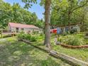 Two houses with landscaping, a large tree, and a mailbox at 2620 Alston Chapel Rd, Pittsboro, NC 27312