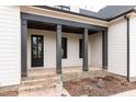 Inviting front porch with brick steps and dark columns at 1690 Terry Rd, Durham, NC 27712