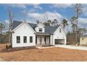 Modern farmhouse exterior with white siding and dark accents at 1690 Terry Rd, Durham, NC 27712