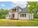Rear view of a two-story home showcasing a large deck and balcony at 242 Lakestone Estates, Pittsboro, NC 27312