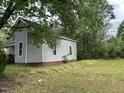 Gray house with red brick foundation and large yard at 529 Dexter St, Rocky Mount, NC 27803