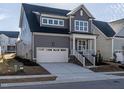 Attractive two-story gray home with white trim and attached garage at 1713 Grassy Falls Ln, Wendell, NC 27591