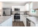 Modern kitchen with stainless steel appliances and granite countertops at 213 Day Farm Dr, Lillington, NC 27546