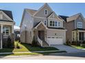 Two-story home with neutral siding, brick accents, and a two-car garage at 1719 Grassy Falls Ln, Wendell, NC 27591