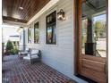 Front porch with seating and brick flooring at 1113 Destination Dr, Apex, NC 27523