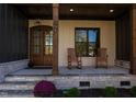 Inviting front porch with rocking chairs and double front doors at 40 Harvest View Way, Franklinton, NC 27525