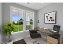 Bright home office with large windows, desk, and view of backyard at 80 Plainfield Ln # Holly Georgian, Lillington, NC 27546