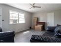 Living room with gray walls, wood-look floors, and black sofas at 251 Tonker Dr, Roxboro, NC 27573