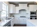 Modern kitchen with white shaker cabinets, quartz countertops, and stainless steel appliances at 213 Beacon Dr, Pittsboro, NC 27312