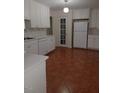 White cabinets, tile floors, and modern appliances at 511 Normandy St, Cary, NC 27511