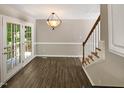 Dining room with laminate flooring, access to deck and stairs at 4425 Woodlawn Dr, Raleigh, NC 27616