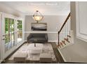 Virtually staged dining room with access to deck and stairs at 4425 Woodlawn Dr, Raleigh, NC 27616