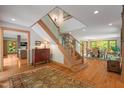 Bright and spacious entryway with hardwood floors, wooden staircase, and views to other rooms at 643 Brookview Dr, Chapel Hill, NC 27514