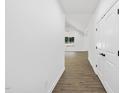 Bright hallway with hardwood floors and white walls at 242 Sequoia Dr, Louisburg, NC 27549