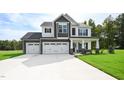 Two-story home with three-car garage and stone accents at 196 Abingdon Farms Dr, Selma, NC 27576
