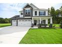 Two-story home with three-car garage and stone accents at 196 Abingdon Farms Dr, Selma, NC 27576