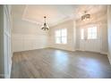 Bright dining room with hardwood floors and elegant chandelier at 196 Abingdon Farms Dr, Selma, NC 27576