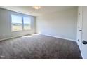 Bright bedroom with neutral carpeting and large windows at 265 Shingle Oak Rd, Wake Forest, NC 27587